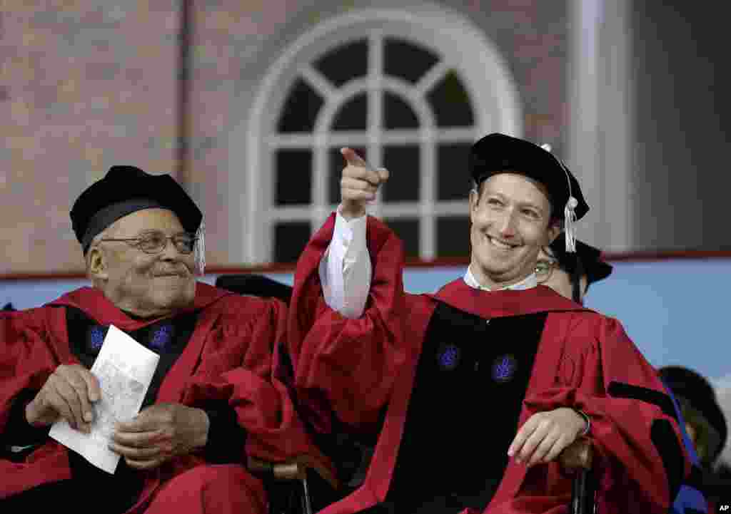 Facebook CEO and Harvard dropout Mark Zuckerberg, right, gestures as actor James Earl Jones, left, looks on while seated on stage during Harvard University commencement exercises, in Cambridge, Massachusetts. Zuckerberg was presented with an honorary Doctor of Laws degree and gave a commencement address.