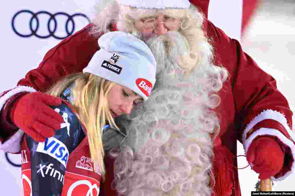 Mikaela Shiffrin of the U.S. celebrates after winning the women's slalom competition with Santa Claus during the FIS Ski World Cup in Levi, Finland.
