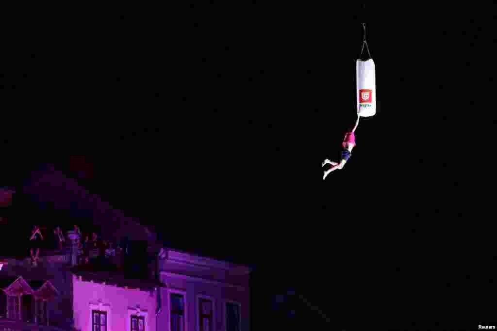 A man attempts to break the world record of the highest trampoline jump in Ljubljana, Slovenia, June 29, 2024.
