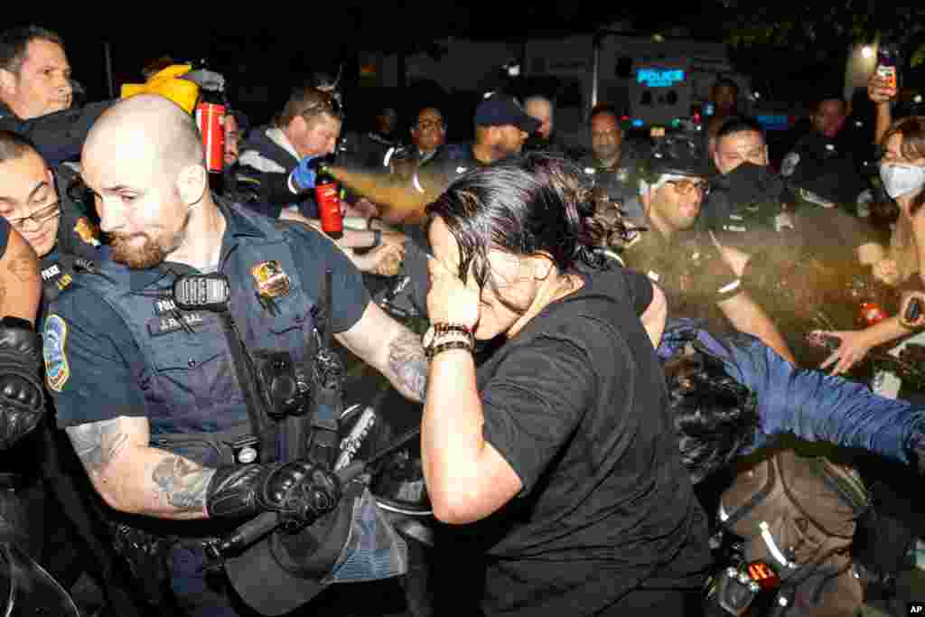 Officers of the Metropolitan Police Department pepper spray demonstrators at George Washington University, in Washington. Police cleared a pro-Palestinian tent encampment at George Washington University and arrested demonstrators, hours after dozens marched to the home of the school’s president.