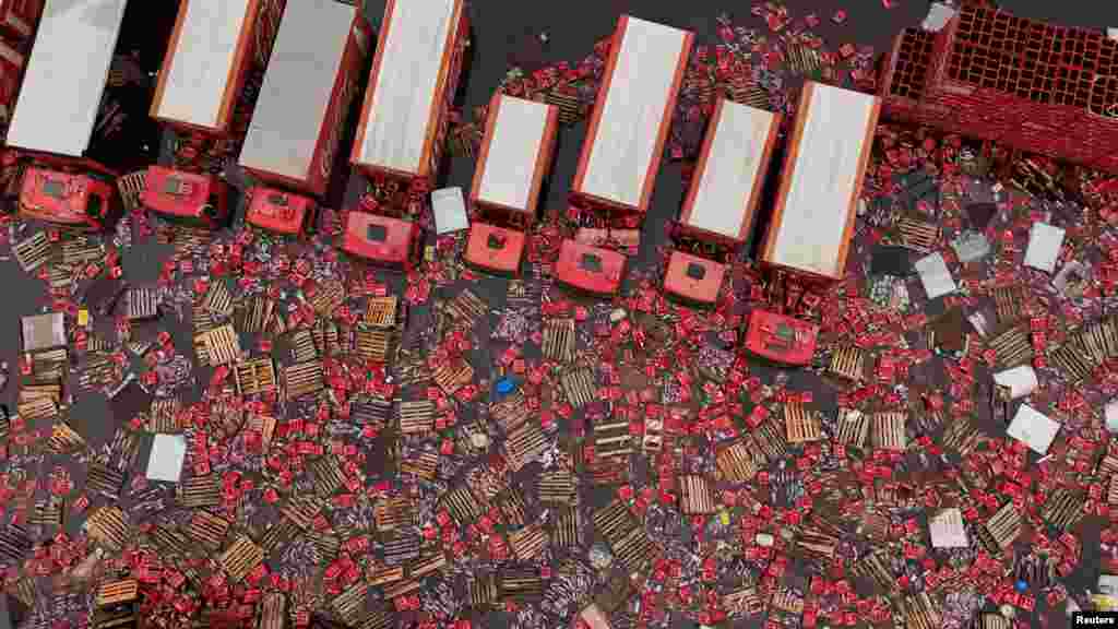 A drone view shows Coca-Cola FEMSA boxes and bottles floating in the water near trucks, amid flooding in Porto Alegre, Rio Grande do Sul state, Brazil, May 19, 2024.