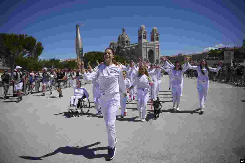 Maria Vysotchanska of Ukraine participates in the Olympic torch relay in Marseille, southern France.