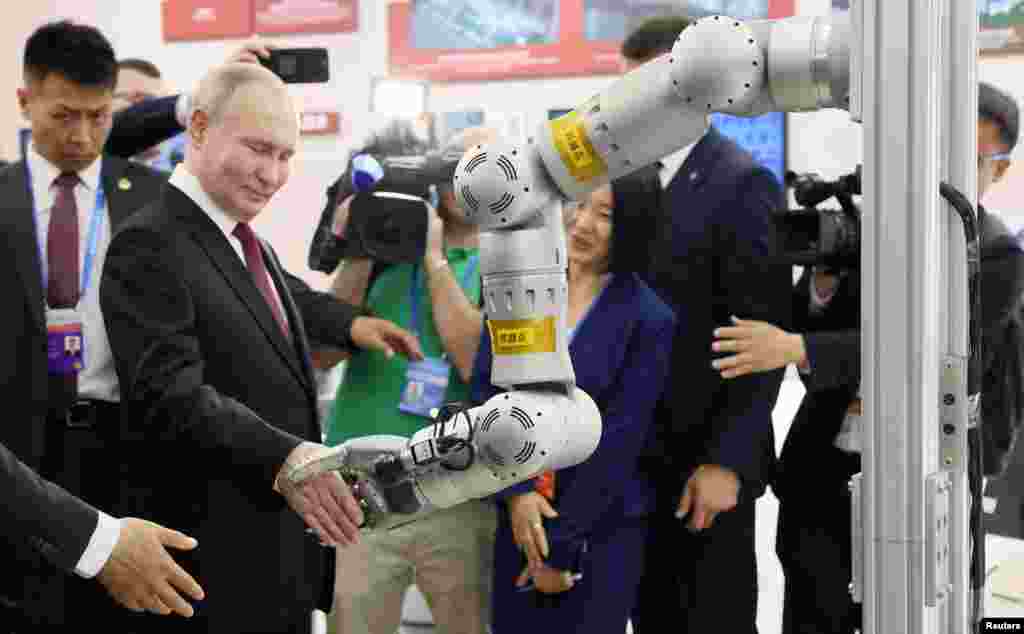 Russian President Vladimir Putin tours an exhibition at the 8th Russian-Chinese EXPO in Harbin, China. (Sputnik/Mikhail Metzel/Pool via Reuters)