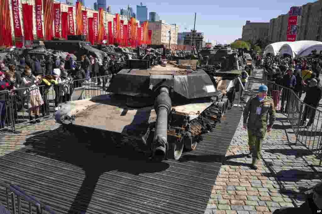 A Russian officer walks along a U.S.-made M1 Abrams tank as he prepares to speak to foreign military attaches during their visit to an exhibition of Western military equipment captured from Kyiv forces during the fighting in Ukraine, in Moscow.
