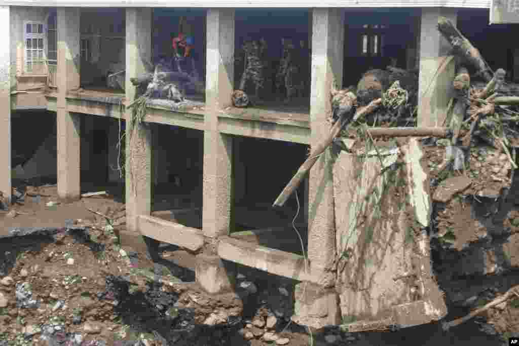 Rescueers inspect the damage by a flash flood in Tanah Datar, West Sumatra, Indonesia.
