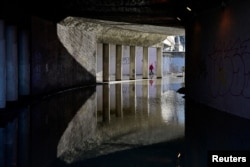 A child walks in a tunnel flooded by the Danube River in Budapest, Hungary, Dec. 27, 2023.