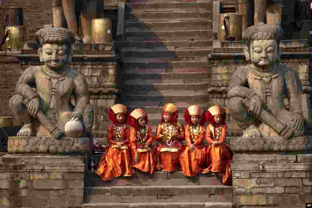 Girls dressed as living goddess Kumari participate in a traditional Newari community music festival in Bhaktapur, Nepal.