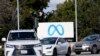 Cars drive past a Meta sign outside of the company's headquarters in Menlo Park, Calif., March 7, 2023.