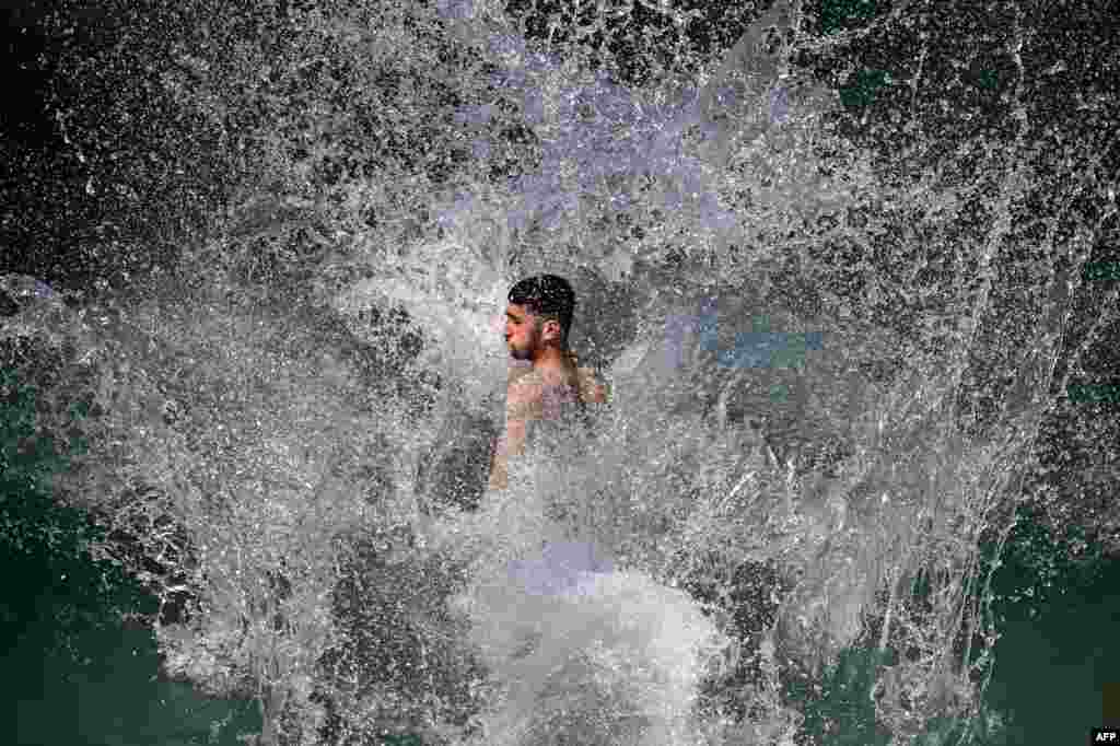 Youth enjoy at a water park on a hot summer day in Lahore, Pakistan.