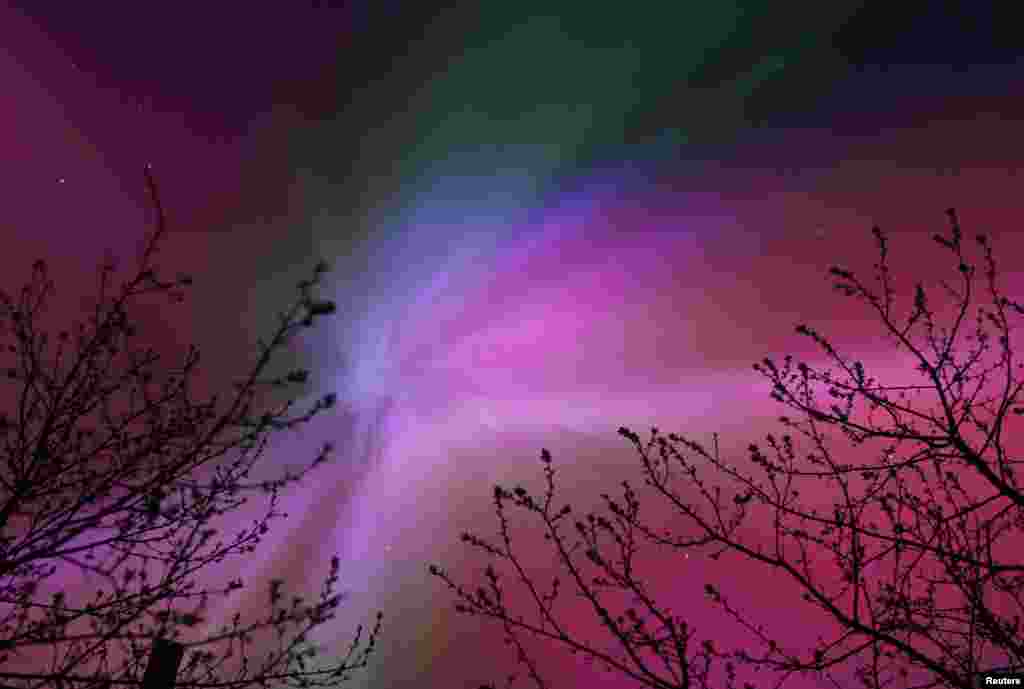 The aurora borealis, also known as the 'northern lights,’ caused by a coronal mass ejection on the Sun, illuminate the skies over the southwestern Siberian town of Tara, Omsk region, Russia, May 11, 2024. 