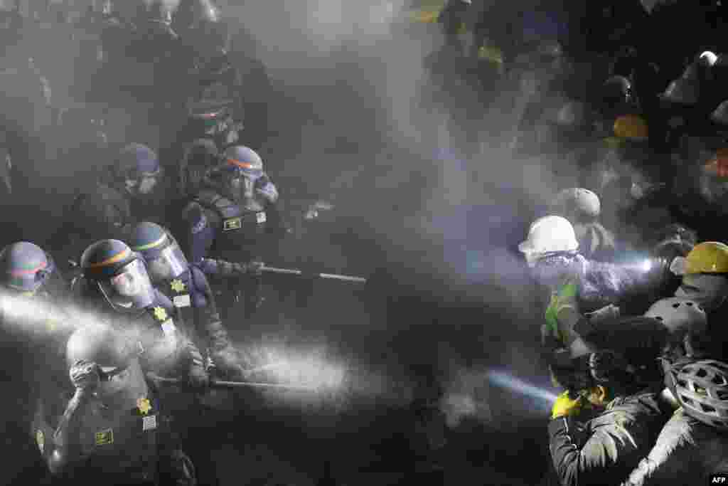 Police face-off with pro-Palestinian students after destroying part of the encampment barricade on the campus of the University of California, Los Angeles (UCLA) in Los Angeles.