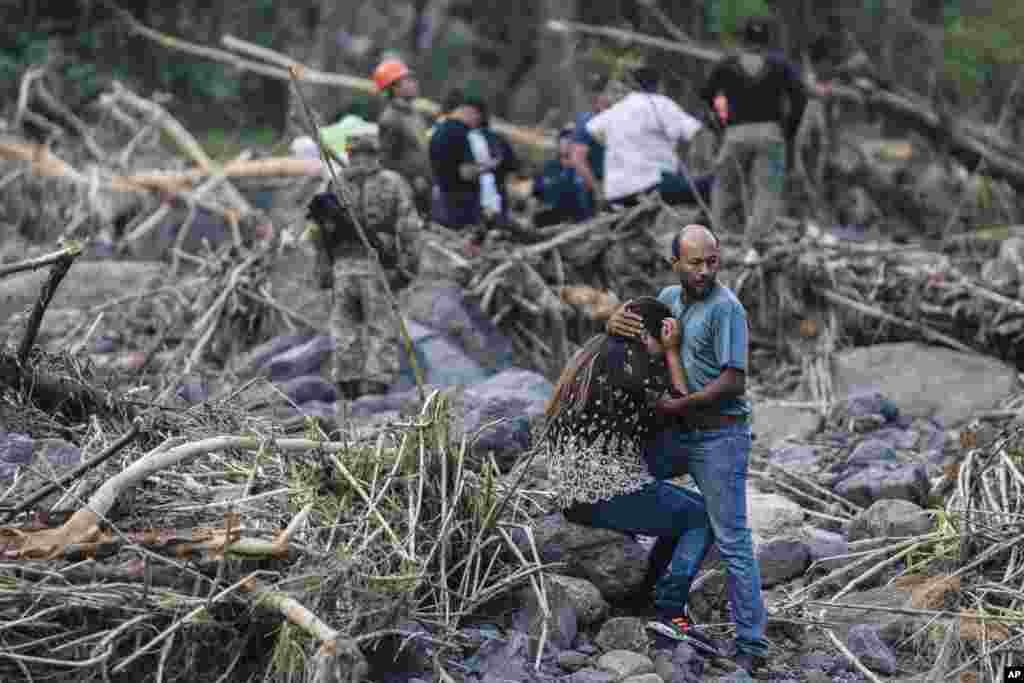 Relatives of police officer Jorge Alberto Ladrón de Guevara react as rescuers recover his body in Alto Lucero, Veracruz, Mexico, July 2, 2024. State authorities said he died in a car accident while checking damaged caused by heavy rain.