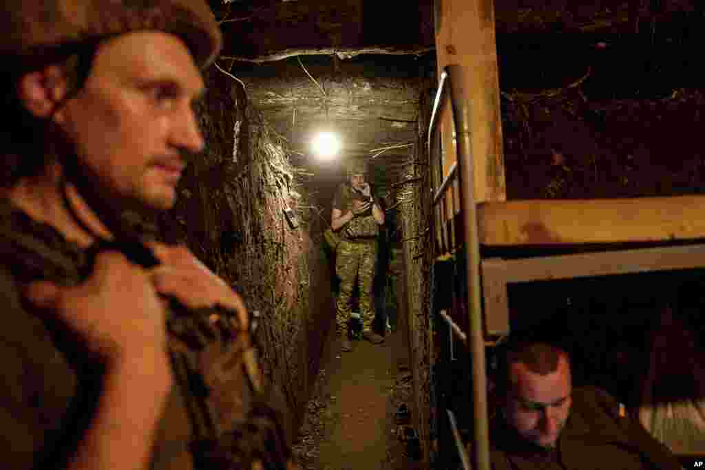 Ukrainian national guard servicemen of Khartia brigade take cover after firing towards Russian positions by a D-20 cannon at the frontline near Kharkiv, Ukraine.