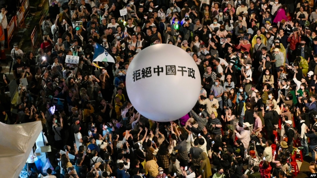 台灣立法院在通過國會改革法案後，支持執政黨民進黨的民眾聚集立法院外，放出「拒絕中國幹政」的氣球。 (2024年5月28日)
