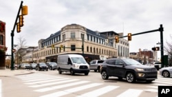 This University of Michigan College photo shows vehicles as they drive through an intersection in Birmingham, Michigan. (Jeremy Little/University of Michigan College of Engineering via AP)