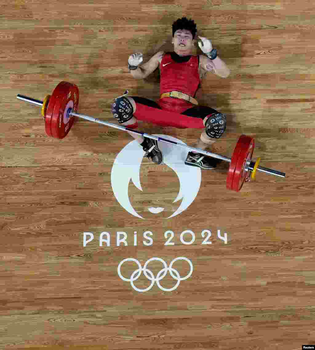 Van Vinh Trinh of Vietnam fails to lift during the men's 61kg weightlifting at the Paris Olympics in Paris, France.