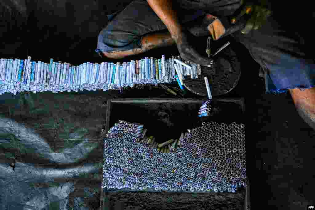 A worker makes firecrackers in the village of Kimbulapitiya on the outskirts of Colombo, Sri Lanka, ahead of the Sinhala and Tamil New Year celebrations.