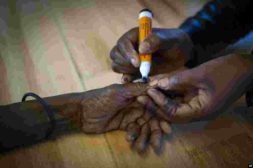 A woman is marked on her hand after casting her ballot during general elections in Nkandla, Kwazulu Natal, South Africa.