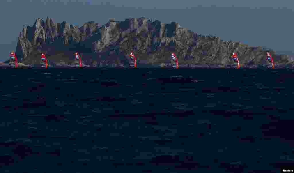 Windsurfers compete in the women's windsurfing event during the Paris Olympics at Marseille Marina, Marseille, France.