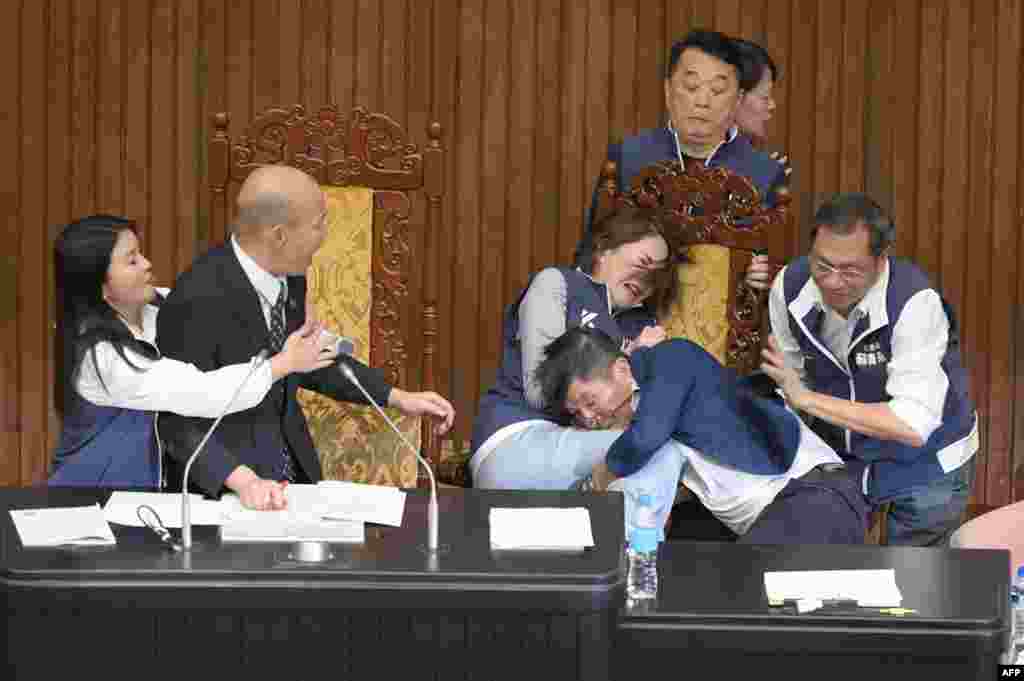 Taiwan's lawmakers exchange blows during voting for a reform bill in parliament, in Taipei.