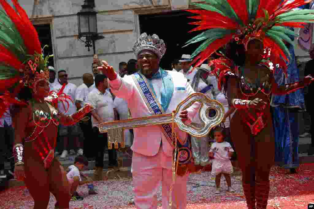 Carnival King Momo, Djferson Mendes da Silva, holds the key to the city during the official start of Carnival in Rio de Janeiro, Brazil.