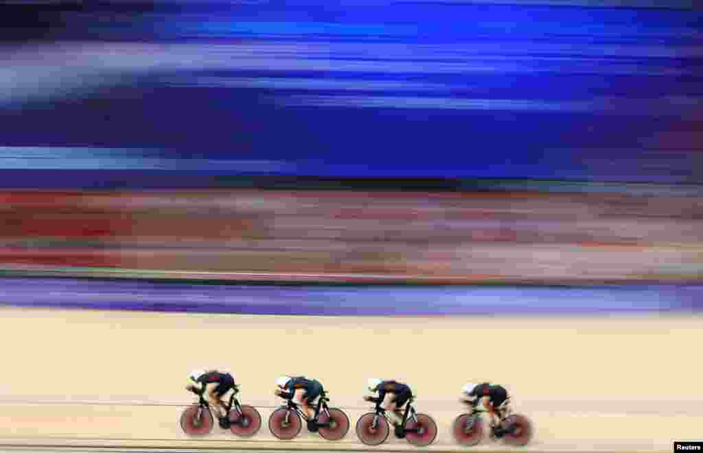 Ethan Hayter, Oliver Wood, Daniel Bigham and Ethan Vernon of Britain compete in the men's track cycling qualifying race during the Paris 2024 Olympics at the Saint-Quentin-en-Yvelines Velodrome, Montigny-le-Bretonneux, France.