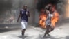 Manifestan kouri pandan kawotchou ap boule pandan yon manifestasyon nan Potoprens, Ayiti, 7 Out, 2023. 