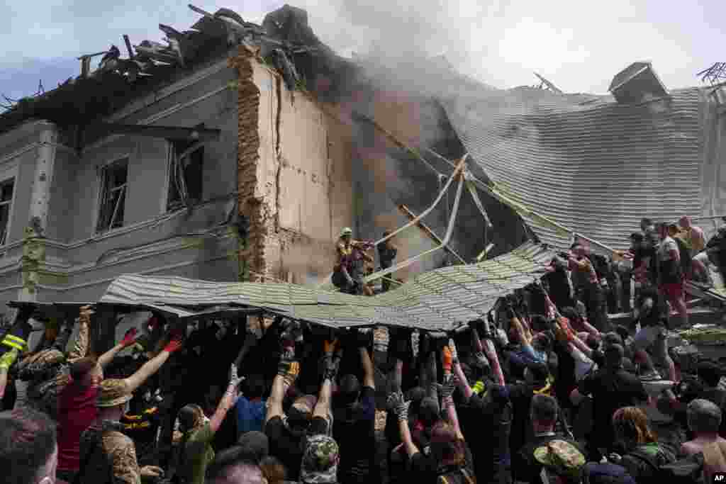 Emergency services work at the site of Okhmatdyt children’s hospital hit by Russian missiles, in Kyiv, Ukraine.