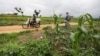 FILE - A man carries sacks of harvested maize on his motorbike from a farm in Masaka Karu area of Nasarawa state, Nigeria, Sep. 1, 2022.