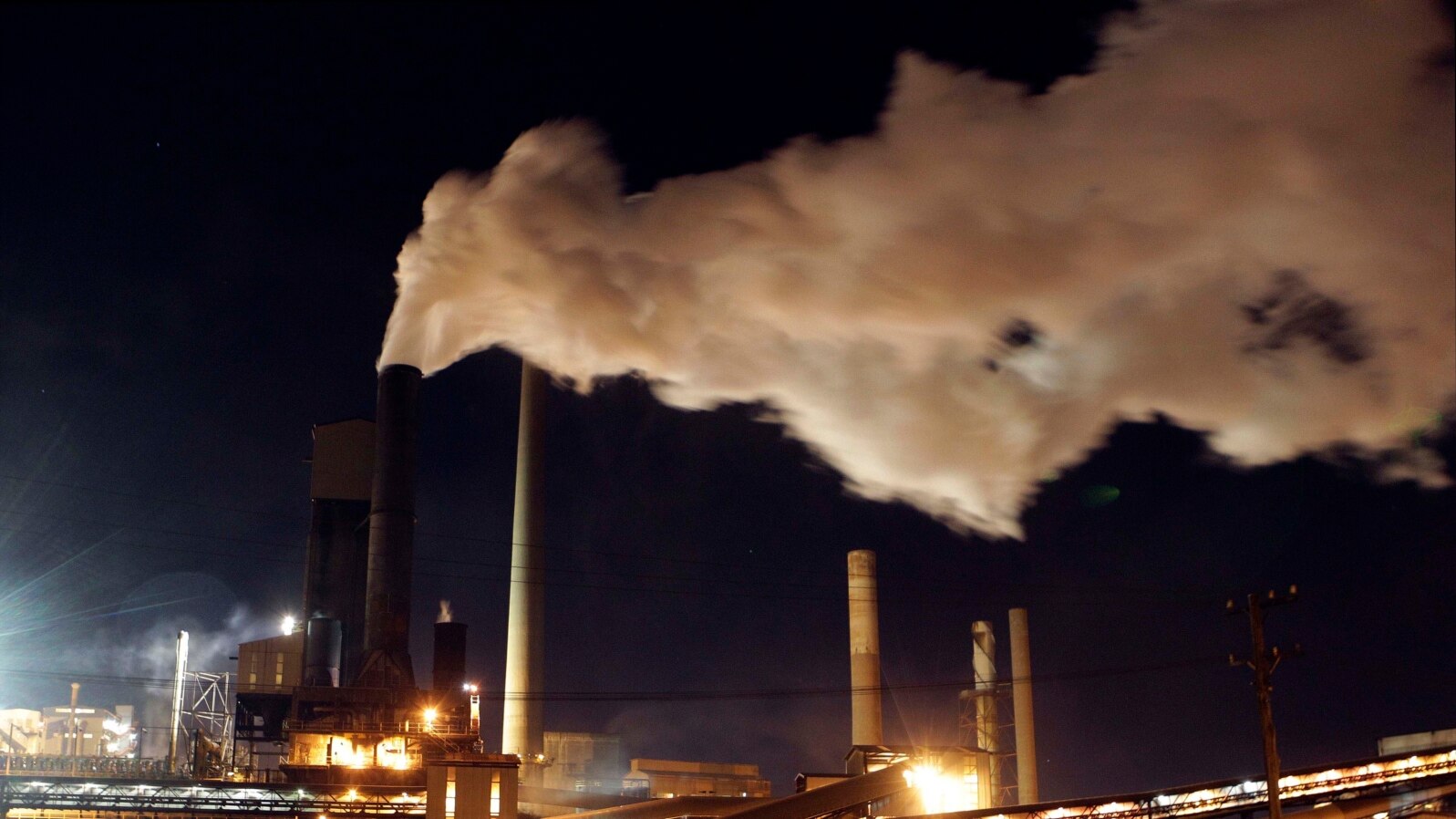 FILE - Steam bellows from a chimney stack at BlueScope Steel's steelworks at Port Kembla, south of Sydney, Australia. 