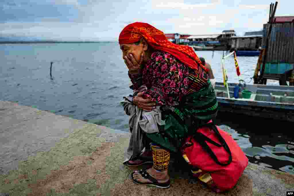 An Indigenous Guna woman waits on the dock for her transfer from Carti Sugtupu island to the mainland, in Guna Yala Comarca, on the Caribbean coast in Panama, June 03, 2024.
