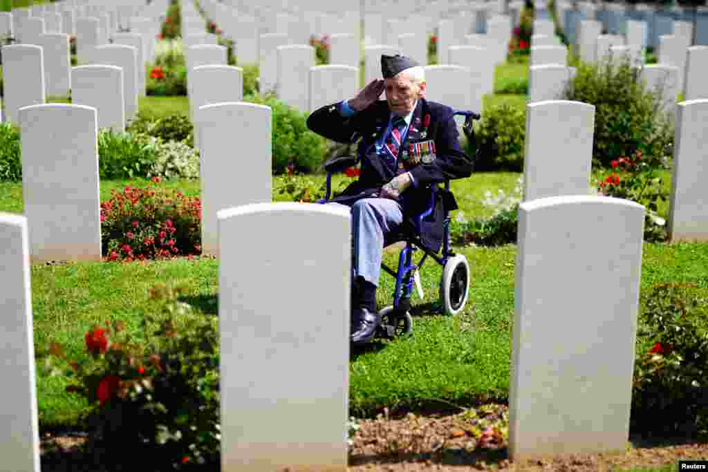 RAF veteran Bernard Morgan, 100, from Crewe, salutes the fallen ahead of the Royal British Legion Service of Commemoration to mark the 80th anniversary of D-Day, at Bayeux War Cemetery in Normandy, France.