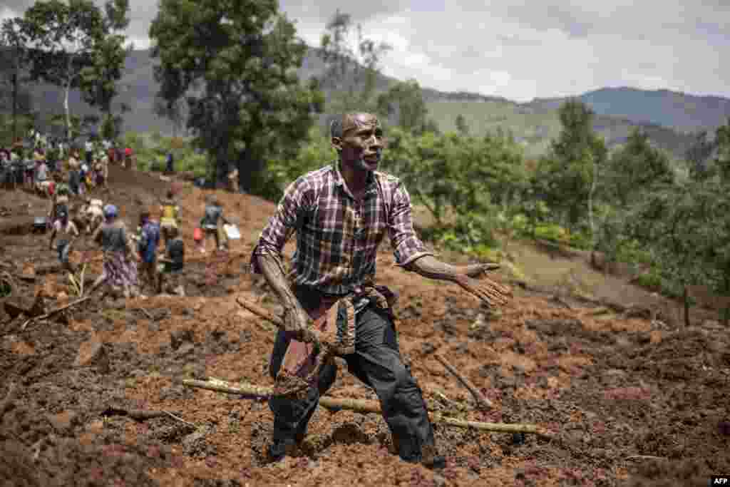 A man reacts as residents and volunteers dig in the mud in search for bodies at the scene of a landslide in Kencho Shacha Gozdi, Ethiopia. The death toll from landslides in a remote region of southern Ethiopia has risen to 257, the United Nations said, warning that the number of victims could soar to up to 500. 