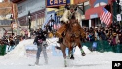 A skijoring team competes in Leadville, Colo., on Saturday, March 2, 2024. Skijoring draws its name from the Norwegian word skikjoring, meaning "ski driving." (AP Photo/Thomas Peipert)