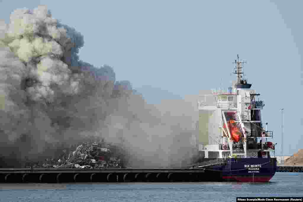 Smoke rises from a fire on a ship that has docked in Koege, Denmark.