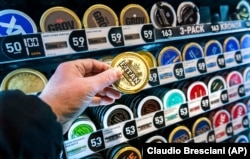 FILE - A man holds a box of snus (snuff), a smokeless tobacco product that’s illegal elsewhere in the European Union but is marketed in Sweden as an alternative to cigarettes. (Claudio Bresciani /TT News Agency via AP, File)