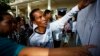 People look through the voters' list after a polling station opened for the general elections in Kandal province, file photo. REUTERS/Damir Sagolj