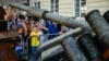Bystanders look at Russian military equipment that was destroyed in fights with the Ukrainian army, displayed as part of an outdoor exhibition on central square of Lviv, Ukraine, Aug.11, 2022.