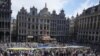A giant Ukrainian flag is unfurled during an event for Ukrainian Independence Day in the historical Grand Place of Brussels