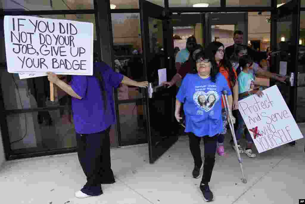 Family, parents and friends file out of a meeting where Uvalde School District Police Chief Pete Arredondo was dismissed by the Board of Trustees of the Uvalde Consolidated Independent School District, Aug. 24, 2022, in Uvalde, Texas.