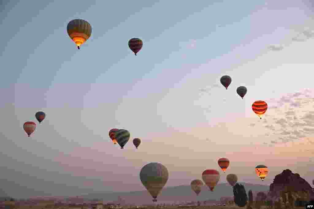 Sight-seeing hot air balloons launch in Goreme Historical National Park, east of Nevesehir (Neapolis) in central Turkey's historical Cappadocia (Kapadokya) region, Aug. 24, 2022.