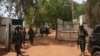 FILE - Nigerian soldiers and police officers stand at the entrance of a forestry college in Kaduna state, on March 12, 2021, after a kidnap gang stormed the school.