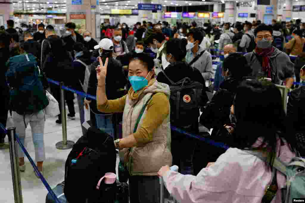 A woman celebrates at Hong Kong&#39;s Lok Ma Chau border checkpoint on the first day China reopens the border amid COVID-19 pandemic in Hong Kong.