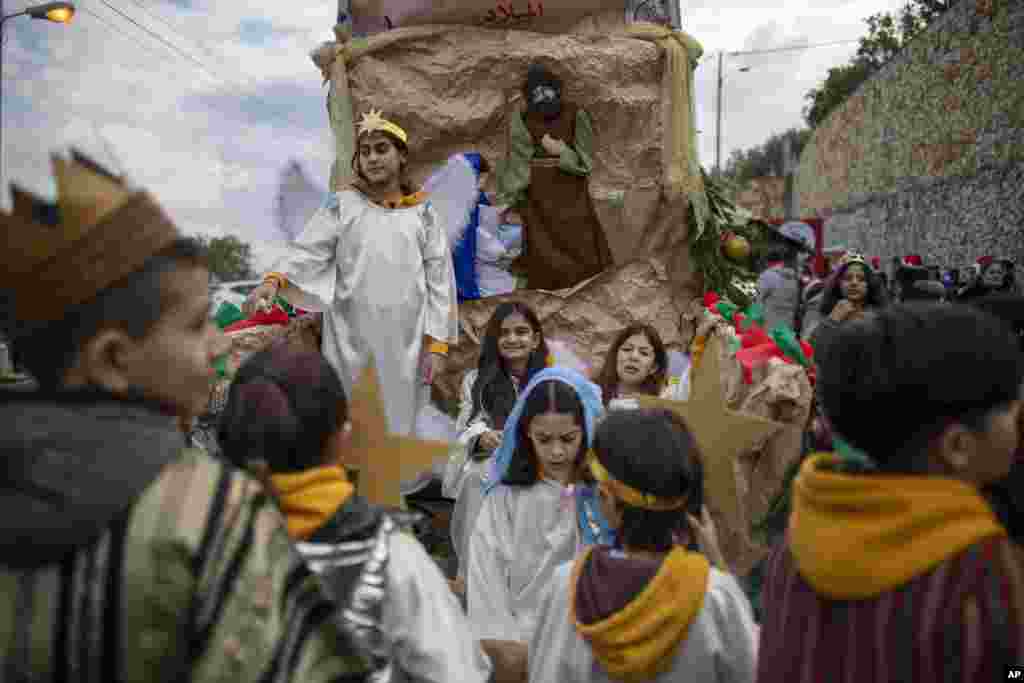 Israeli Arab Christians wear traditional costume waits for the start of the annual Christmas parade in Nazareth, Israel.