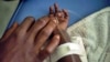 FILE - A child suffering cholera symptoms receives serum at a hospital, Nov. 12, 2010.
