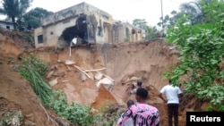 Watu wakitathmini uharibifu baada ya mvua kubwa kusababisha mafuriko na maporomoko ya matope, nje ya mji wa Kinshasa, Jamhuri ya Kidemokrasia ya Congo Dec. 13, 2022.
