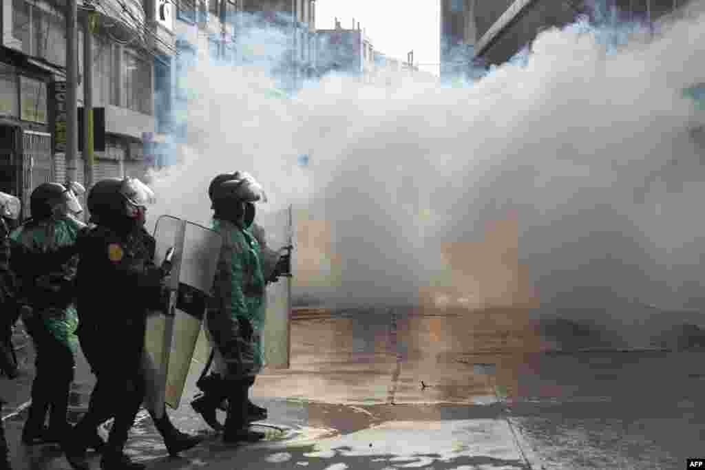Riot police clash with anti-government protesters in Puno, Peru, Jan. 9, 2023. At least 12 people died as anti-government protesters trying to overrun an airport clashed with security forces, officials said.