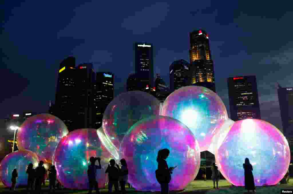 People loook at Atelier Sisu&rsquo;s &quot;Ephemeral&quot;, a light and sound art installation, in Singapore.