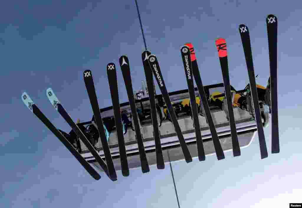 Skiers sit in a chairlift during the winter season opening day at Germany&#39;s highest mountain, the Zugspitze, in Grainau, near Garmisch-Partenkirchen, Germany.
