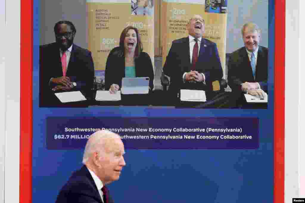 Southwestern Pennsylvania New Economy Collaborative officials react to a quip by U.S. President Joe Biden during an event to discuss his "American Rescue Plan" investments in regional communities, at an auditorium on the White House campus in Washington.